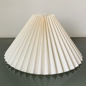 Clip on shade: Pale champagne chintz, pleated lampshade, available in two styles, for table lamps/wall lights. Danish design.