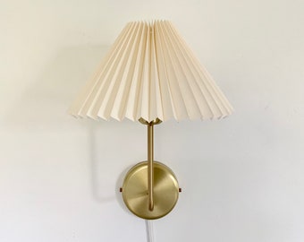 120V, E26 Solid brass wall light, with either plug in or hardwire options, and pleated linen lampshade