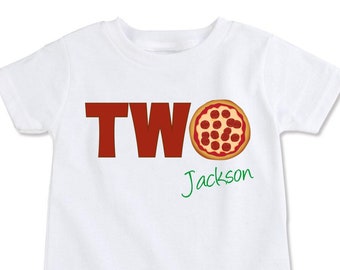 May include: White t-shirt with the word "TWO" in red letters and a pizza graphic. The text "Jackson" is written in green below the pizza.