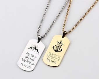 May include: Two silver and gold dog tag necklaces with engraved text and images. The silver necklace has a mountain image and the text "My Love My Life My Friend 12.3.2019". The gold necklace has an anchor image and the text "38.8895°N 77.0352°W NJ, USA".