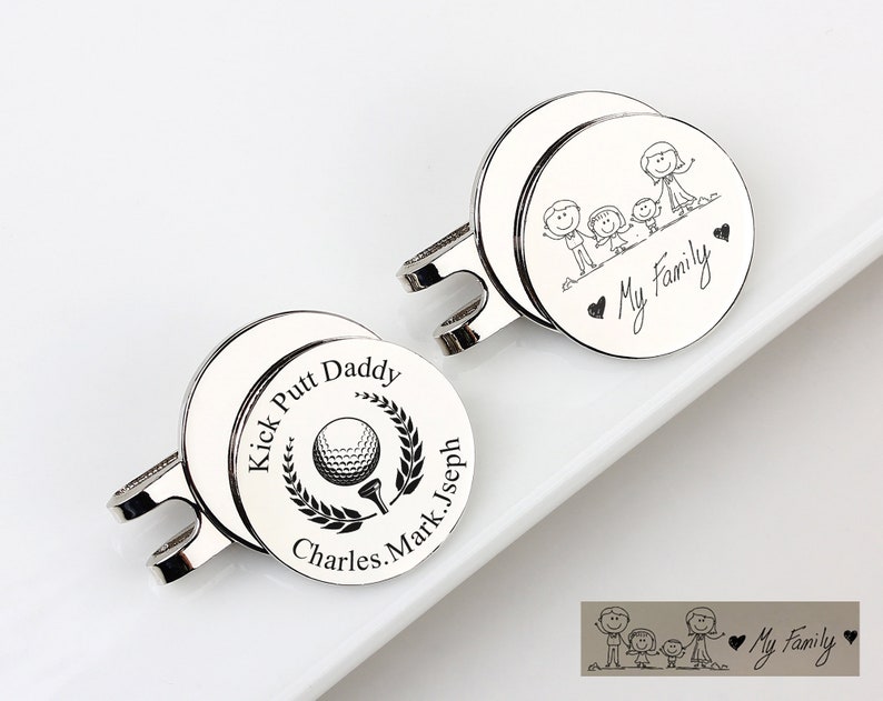 May include: Two silver golf ball markers. One marker has the text "Kick Putt Daddy" around a golf ball and tee graphic. The other marker has a family stick figure graphic and the text "My Family".