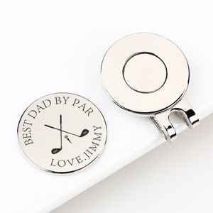 May include: Two silver golf ball markers. One marker has the text "BEST DAD BY PAR LOVE. JIMMY" around a golf club graphic. The other marker has a circular design with a clip. Golf-themed gift.