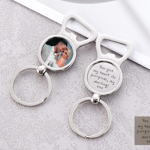 May include: Silver bottle opener keychain with a photo insert and a personalised inscription that reads "You give my heart its purpose, my darling! xoxo".