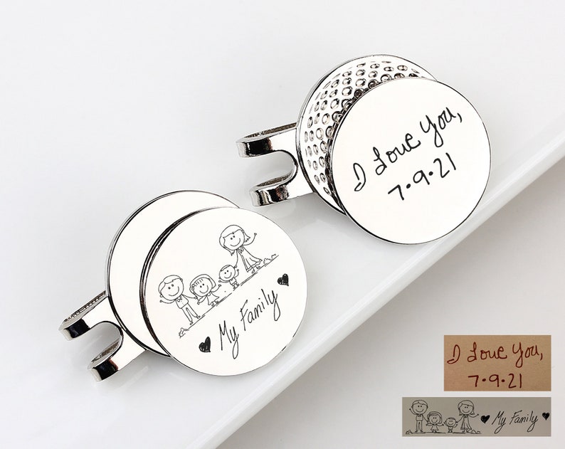 May include: Silver cufflinks with engraved designs. One cufflink features a golf ball design with the inscription "I Love You, 7.9.21." The other cufflink has a family stick figure design with the words "My Family."