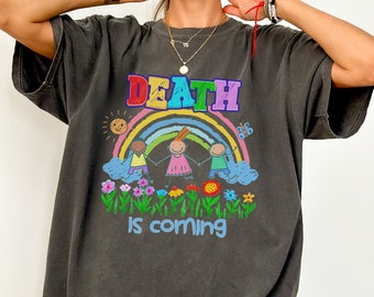 May include: A dark gray t-shirt with a colorful rainbow and three stick figures holding hands. The text "DEATH IS COMING" is printed below the rainbow.