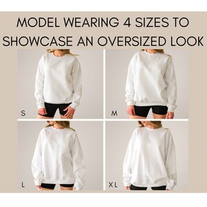 May include: A model is wearing a white sweatshirt in four different sizes: S, M, L, and XL. The model is wearing black shorts and the sweatshirt is oversized in each size.