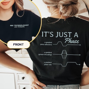 May include: Black t-shirt with the text "MRI TECHNOLOGIST LISA RT(R)(MR)" on the front. The back of the shirt says "IT'S JUST A Phase" with MRI gradient diagrams. A medical professional shirt.