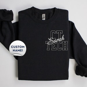 May include: Black sweatshirt with white text that reads "CT Sarah TECH" on the front.