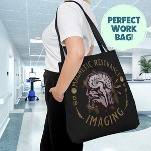 May include: Black tote bag with a gold graphic of a brain with lightning bolts and the text "Magnetic Resonance Imaging".