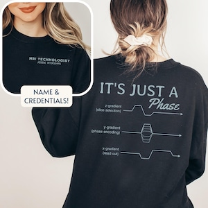 May include: Black sweatshirt with the text "MRI Technologist" and "It's Just A Phase" with a diagram of a phase encoding sequence.