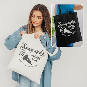 May include: Two tote bags with the text "Sonography Imaging Club Scan 'Till It Hertz" and a stylized ultrasound wand graphic. One bag is white with gray text and the other is black with white text.