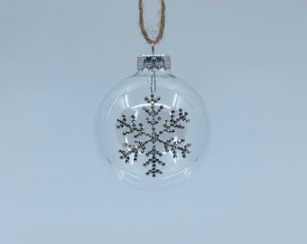 Round plastic Christmas ornament. Handmade silver rhinestone snowflake design.