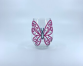 Mini stemless wine glass. Holds 8 oz. Stands 3.5 inches in height. Pink and black butterfly Diamond Dotz rhinestone design.