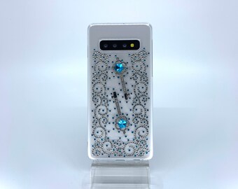 Galaxy S10 case. PC material. Unique Handmade. Blue and silver rhinestones in a swirl design. Key charms. Transparent, protective.