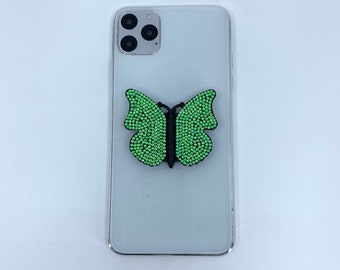 Black butterfly phone stand grip with light green rhinestones. Wings adjust to many levels & butterfly turns on base. Fits all phone models.