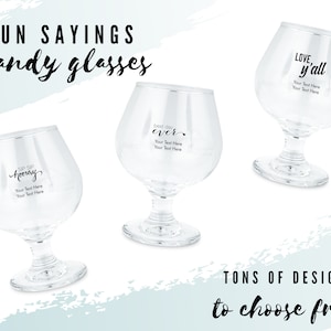 May include: Three clear brandy glasses with different fun sayings printed on them. The sayings are "Sip Sip Hooray", "Best Day Ever", and "Love y'all".