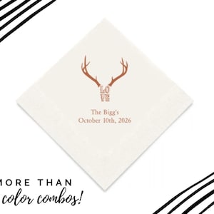 Pode incluir: Guardanapo de papel branco com um design de chifres marrons e a palavra "LOVE" em uma fonte estilizada. O texto "The Bigg's October 10th, 2026" está impresso abaixo dos chifres.