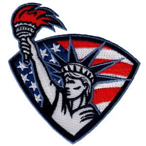 May include: Embroidered patch featuring the Statue of Liberty holding a torch, with an American flag in the background. The patch is blue, red, and white.