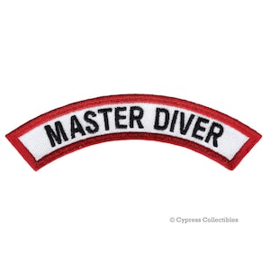 May include: White patch with red trim and the text "MASTER DIVER" in black lettering. The patch is curved in the shape of an arc.