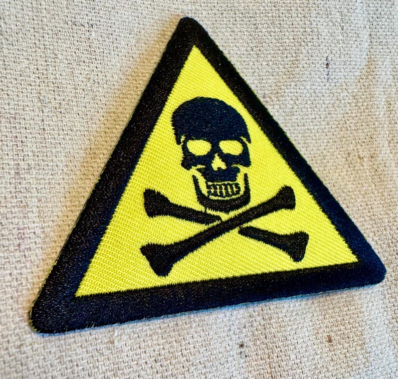 May include: Yellow triangle warning sign with a black skull and crossbones.