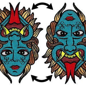 May include: Embroidered patch featuring a teal demon face with red horns, a red tongue, and yellow fangs. The design includes intricate details and is surrounded by a brown and gold border. The image shows the face in two orientations.