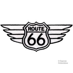 May include: Black and white embroidered patch with a Route 66 sign with wings. The sign is white with black lettering and the wings are white with black outlines.
