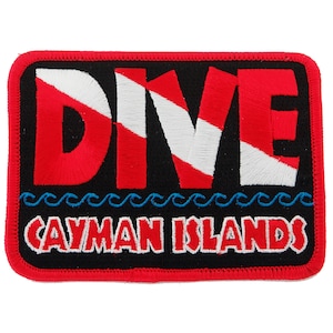 Puede incluir: Parche bordado en rojo, blanco y azul con la palabra "DIVE" y el texto "Cayman Islands" debajo. El parche tiene un borde rojo y un fondo negro.