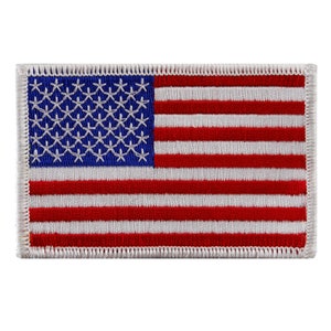 May include: A white embroidered patch with a red, white, and blue American flag design. The flag has 13 red and white stripes and 50 white stars on a blue field.