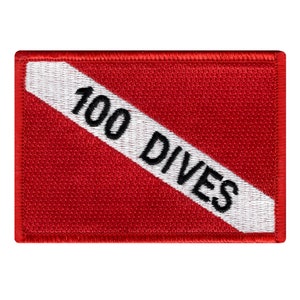 May include: Red and white scuba diving patch with the text "100 DIVES" in black.