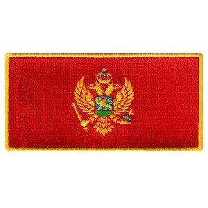 May include: A red embroidered patch with a gold embroidered coat of arms featuring a lion and eagle. The patch has a gold border.