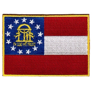 May include: An embroidered patch featuring the state flag of Georgia. The patch is red, white and blue with a gold border and depicts the state seal with the words "In God We Trust".