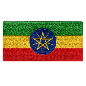 May include: An embroidered patch of the Ethiopian flag. The flag is green, yellow, and red with a blue circle in the center containing a gold star with eight points.