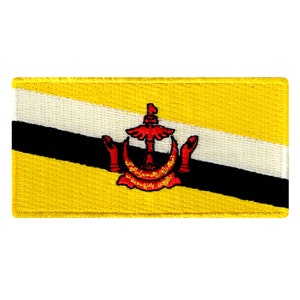 May include: A yellow, black, and white embroidered patch with a red and gold crest in the center. The crest features a crescent moon, five-pointed star, and a winged, stylized 'V' shape.