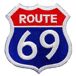 May include: A blue and red highway sign with white text and numbers. The sign reads "ROUTE 69".