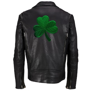 May include: Black leather jacket with a green shamrock patch on the back.
