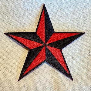 May include: A red and black nautical star patch. The star is embroidered with a black outline and red and black stripes.