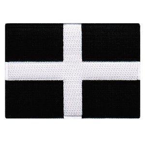 May include: A black and white flag with a white cross on a black background. The flag is made of a woven fabric.