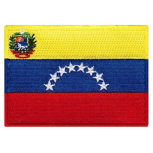May include: A yellow, blue, and red Venezuelan flag patch with a coat of arms in the top left corner and a white arc of stars in the center.