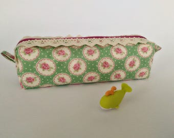 Square green and pink floral print fabric clutch.