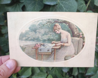 Old vintage postcard Woman writing. 20s