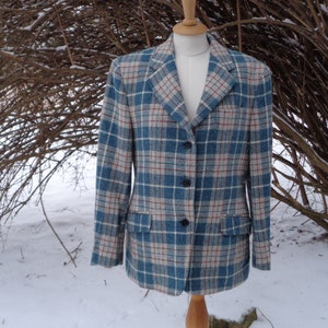 May include: A blue, white and red plaid blazer with a button fastening.