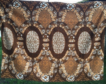 May include: Brown fabric with a repeating pattern of white and brown ovals and floral designs.
