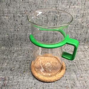 Bodum Denmark Bistro coffee cup with green plastic handle and cork coaster