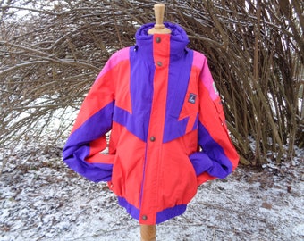 May include: A red, purple, and pink ski jacket with a zipper closure and a hood. The jacket has a logo on the left chest.