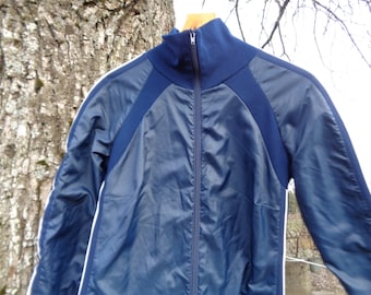 Könnte beinhalten: Eine marineblaue Jacke mit weißen Streifen an den Ärmeln und einem Reißverschluss.