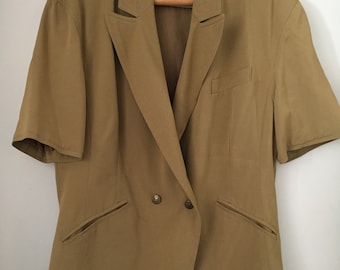 May include: A khaki short-sleeved blazer with a double-breasted closure and two pockets. The blazer has a label that says "PTA" on it.