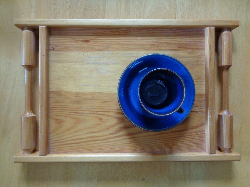May include: A wooden tray with a blue and gold saucer and cup on top. The tray has a natural wood finish and is made of solid wood.