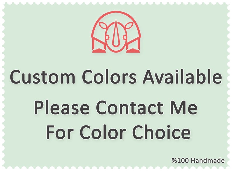 May include: A light green square with a red rhino illustration. The text "Custom Colors Available" is written in black. Below the text is "Please Contact Me For Color Choice" in black. The bottom right corner of the square has the text "100% Handmade" in black.