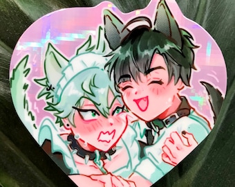 May include: A holographic sticker featuring two anime characters with wolf ears. The character on the left has green hair and is wearing a white shirt with a black collar. The character on the right has black hair and is wearing a white shirt with a black collar and a black choker.