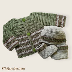 May include: A green crocheted cardigan with brown and white stripes, a matching crocheted hat, and a pair of crocheted booties.